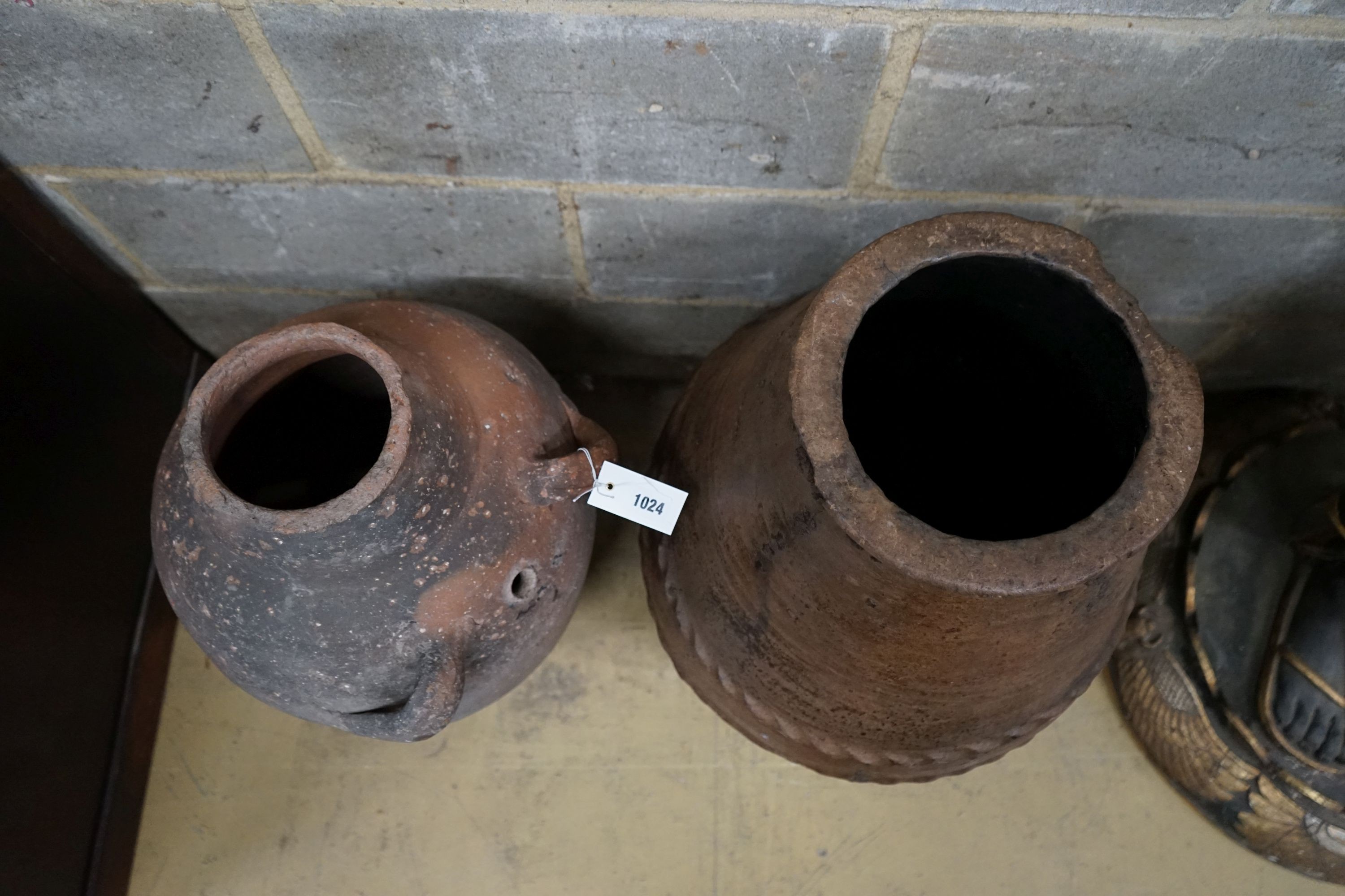 Two Greek style earthenware oil jars, largest height 67cm